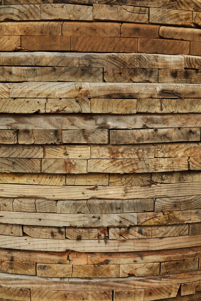 Different timber panels stacked together in heap and prepared for building and maintenance in workshop